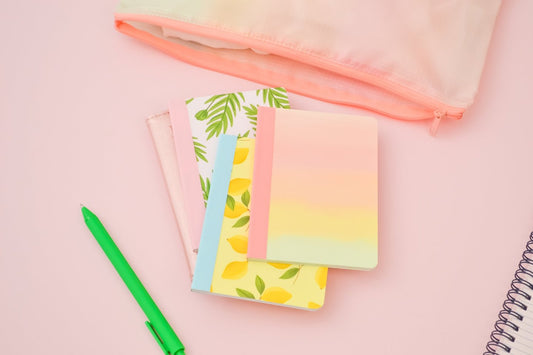 a pink and green toothbrush sitting on a pink surface 